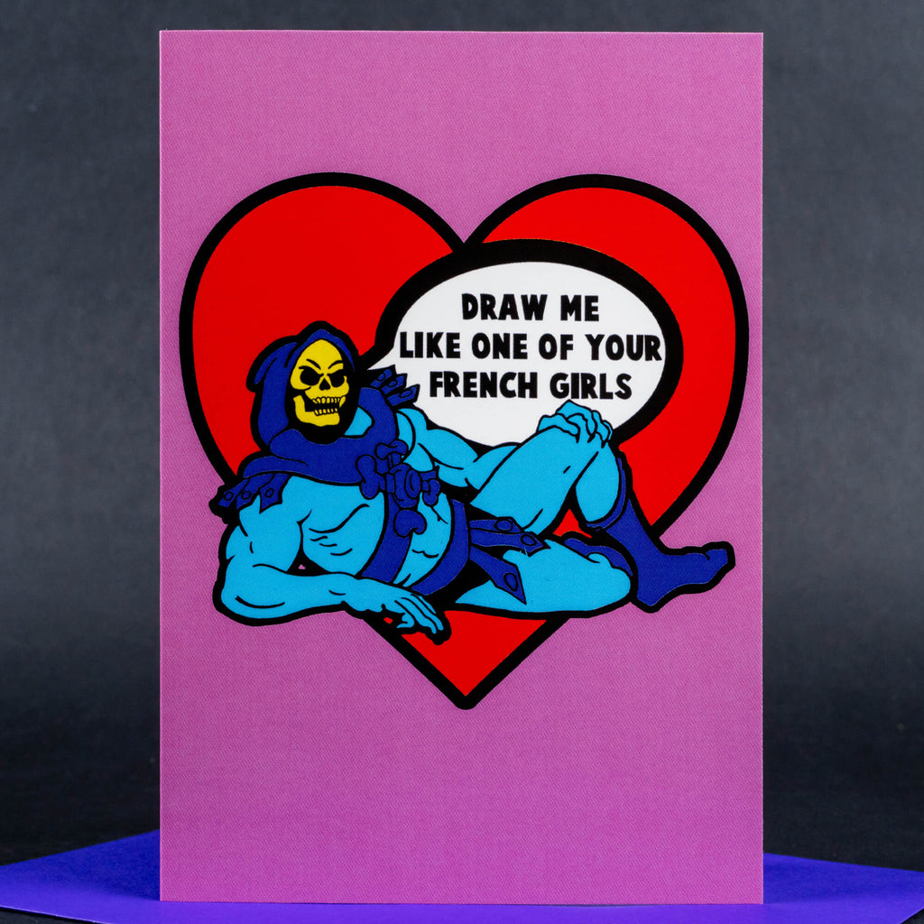 A quirky Valentine’s or humorous greeting card featuring Skeletor lounging seductively within a red heart. The caption “Draw me like one of your French girls” is written inside the heart in a bold, comic-style font. The background is a playful purple hue.
