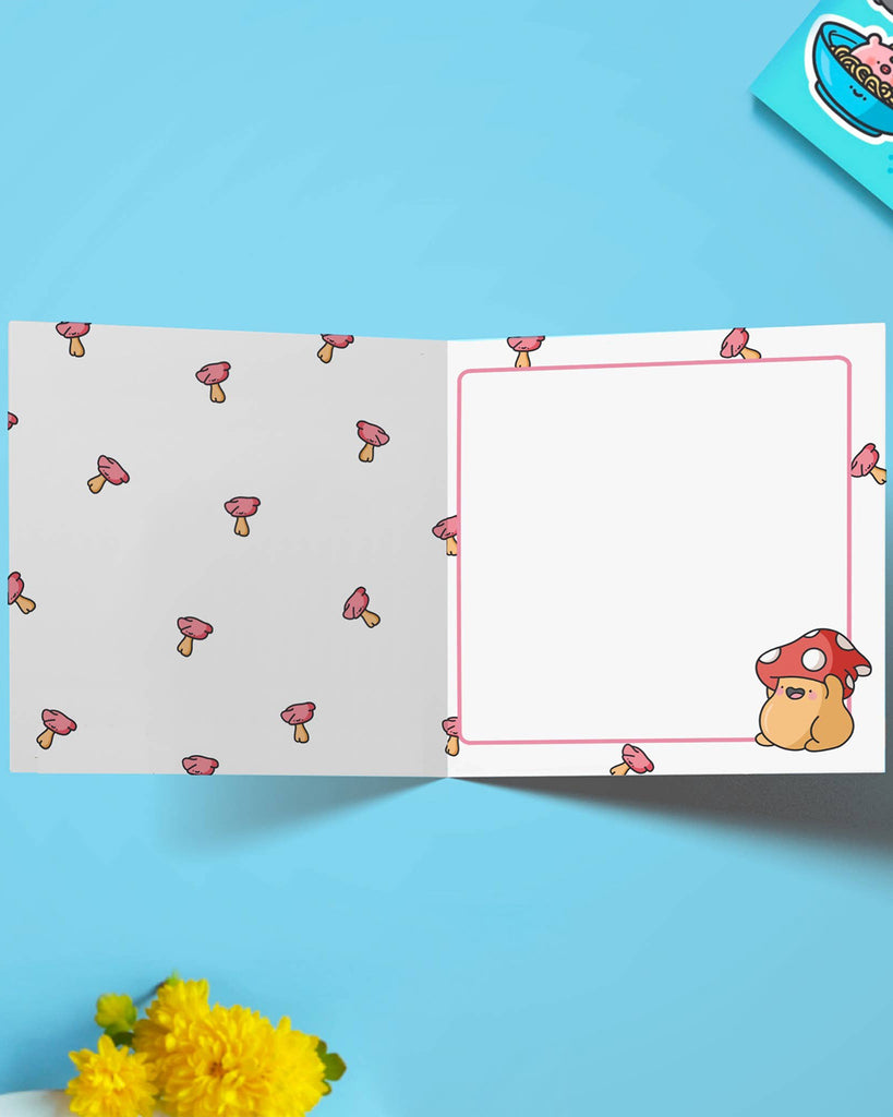 Inside view of the mushroom greetings card stocked at Rebel Romance. The left side is patterned with mini pink mushrooms, and the right side has space to write a message with a cute mushroom character in the corner. A sweet and quirky illustrated card perfect for alternative stationery fans.