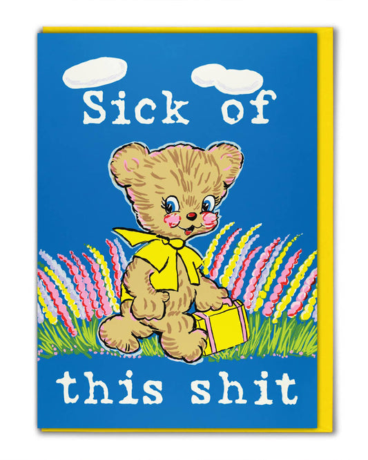 Rebel Romance Sick Of This Shit greeting card by Magda Archer. Featuring a kitschy retro bear illustration with a yellow scarf and suitcase against a bright blue background with colourful flowers. The bold slogan reads "Sick of this shit," blending cute vintage art with dark humour. Perfect funny rude card for millennials who love quirky, alternative gifts.