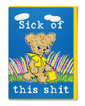 Rebel Romance Sick Of This Shit greeting card by Magda Archer. Featuring a kitschy retro bear illustration with a yellow scarf and suitcase against a bright blue background with colourful flowers. The bold slogan reads "Sick of this shit," blending cute vintage art with dark humour. Perfect funny rude card for millennials who love quirky, alternative gifts.