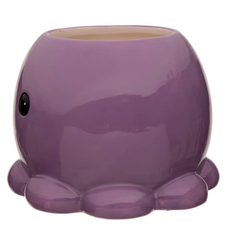 Side angle of the Rebel Romance octopus mug showing one cute black eye and part of its tentacle-like base in glossy purple ceramic.