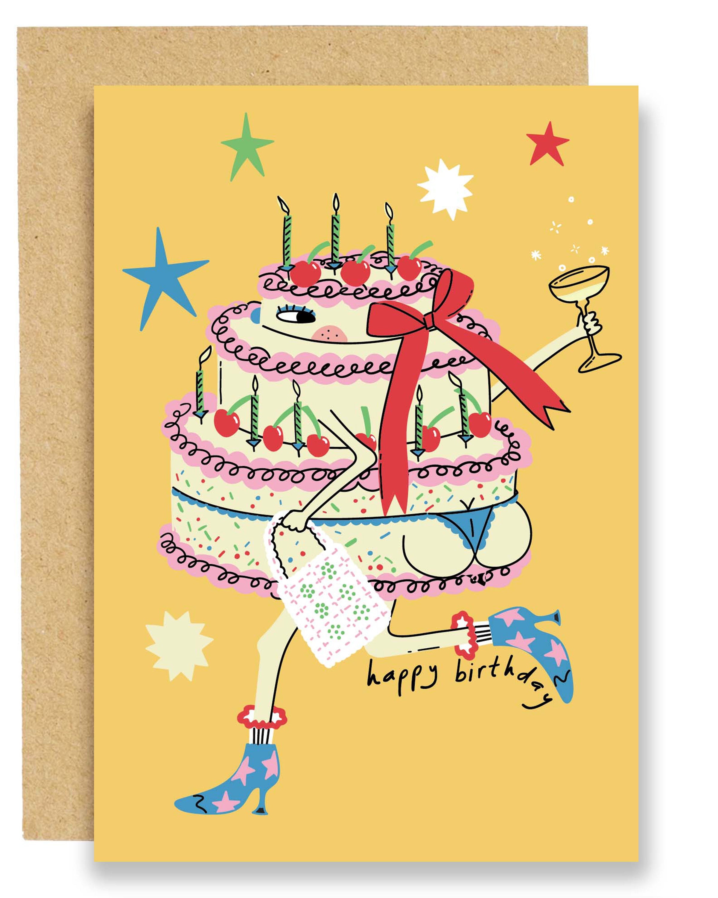 Illustrated birthday card showing a colourful tiered cake with legs wearing blue starry boots, holding a champagne glass and a present, on a bright yellow background with stars, paired with a brown Kraft envelope.