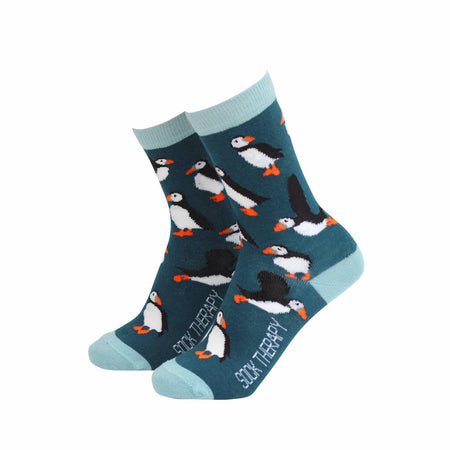 Eco-friendly Smiling Faces puffin socks made from bamboo, showcasing charming puffin birds on teal fabric with contrasting pale blue heels and cuffs. Shop playful novelty socks at Rebel Romance