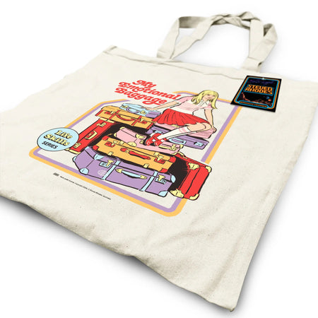 A natural fabric tote bag featuring Steven Rhodes’ retro-style “My Emotional Baggage” design. The illustration shows a blonde girl sitting on a pile of colourful suitcases with the words “My Emotional Baggage” in bold red letters. Playful and self-aware, this tote combines a quirky aesthetic with functionality.