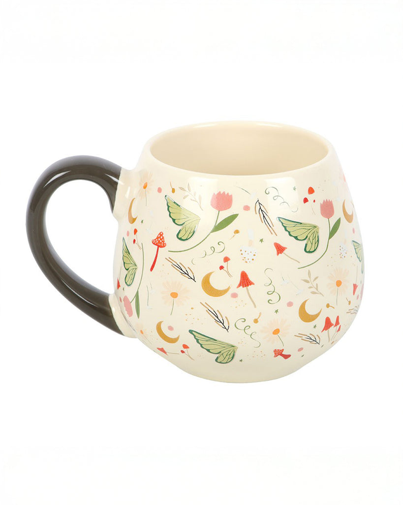 Side angle of the Rebel Romance Fairy Folklore Print Rounded Mug, revealing its softly curved shape, dark handle and enchanting botanical and celestial motifs. A magical ceramic mug that blends cottagecore and fairycore style, perfect for enjoying tea or coffee in style.