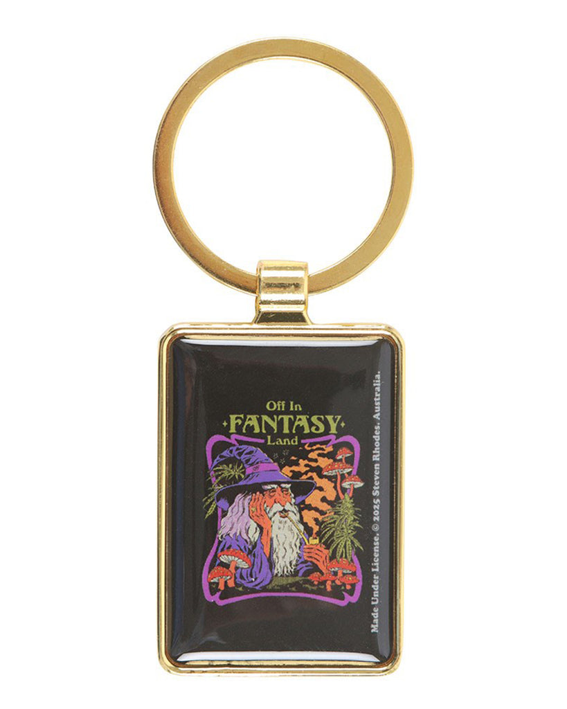 Front view of the Rebel Romance Steven Rhodes Fantasy Land keyring. Features a gold frame with glossy enamel artwork of a wizard smoking a pipe surrounded by mushrooms and psychedelic plants, with the phrase “Off in Fantasy Land.” A fun retro-inspired keyring for gothic and alternative fashion fans.