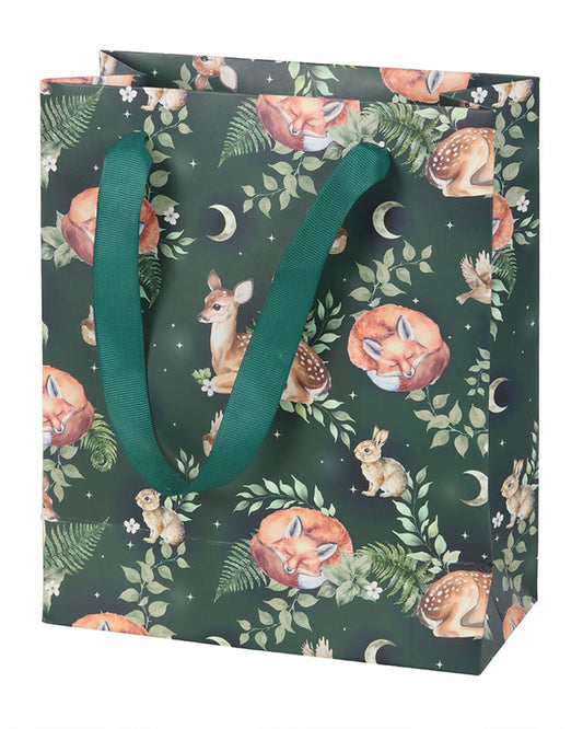 A dark green 23cm gift bag from Rebel Romance featuring a whimsical forest print with sleeping foxes, fawns, rabbits, ferns and crescent moons, finished with sturdy green ribbon handles. A magical woodland design perfect for gifts.
