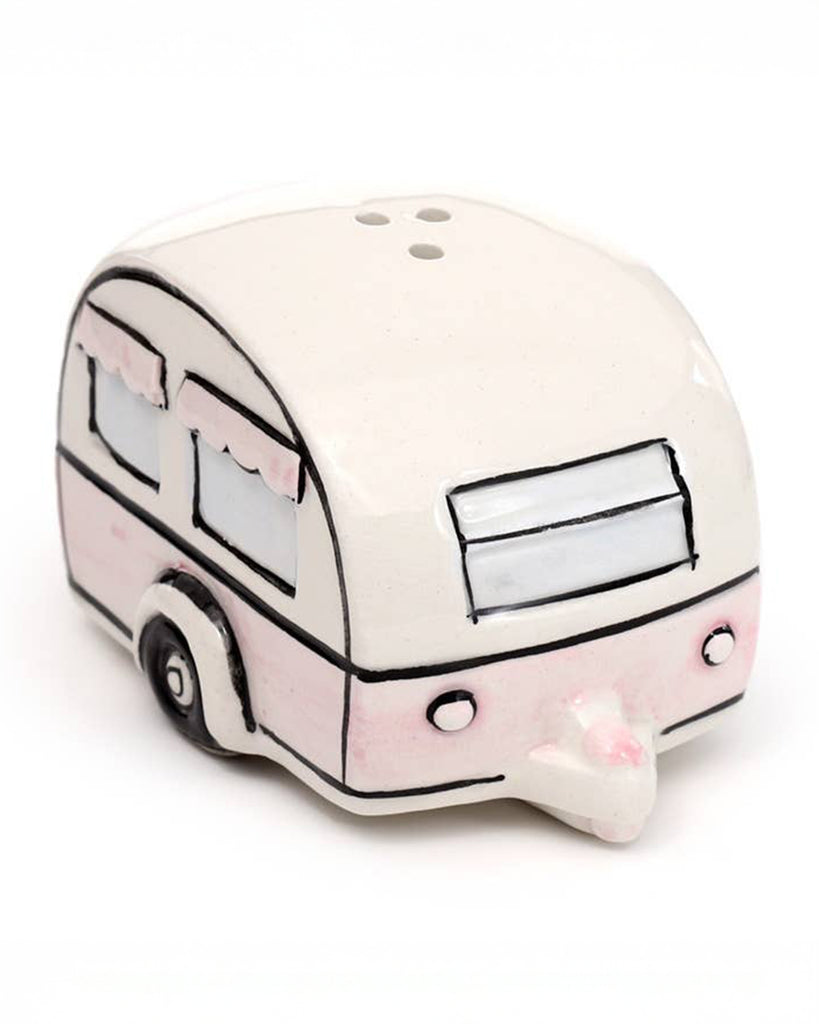 A ceramic salt or pepper shaker shaped like a vintage caravan in cream and pastel pink. Features illustrated windows with pink scalloped curtains. Part of the Home Is Where You Park It set from Rebel Romance, a UK brand for alternative home décor lovers.