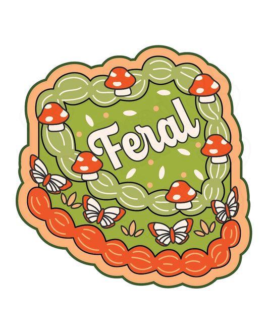 Whimsical green and orange heart-shaped vinyl sticker featuring the word "Feral" in bold white lettering, surrounded by red mushrooms, butterflies, and leaf sprinkles. Designed by FUN CLUB and sold by Rebel Romance, a UK brand celebrating alternative, millennial-friendly aesthetics. High-quality weatherproof sticker ideal for laptops, water bottles, and more.