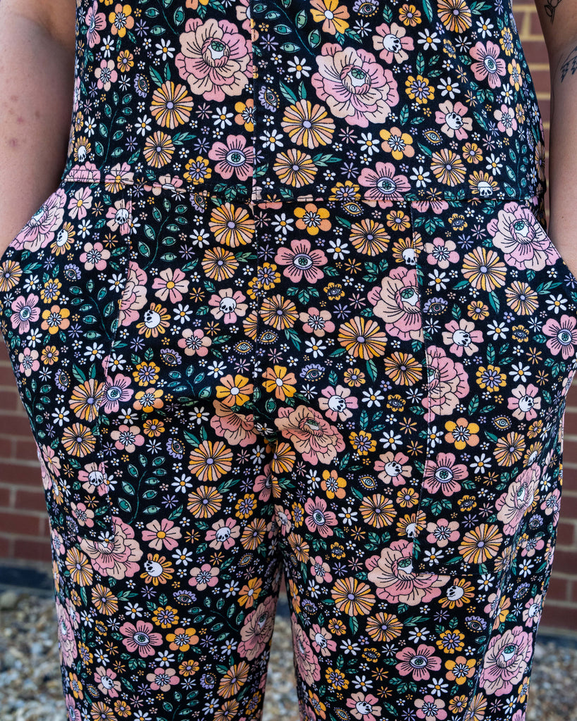 Floral patterned pants with a colorful design on a dark background