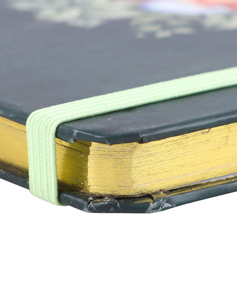 Green Sleeping Fox A5 Notebook
Alt text: An A5 notebook with a forest green cover featuring a curled-up fox sleeping within a circle of leaves, flowers, and a crescent moon. Surrounded by cosy decor and a gold pen.