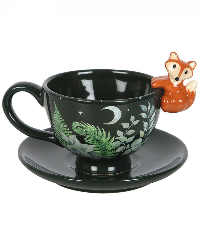 Side view of the Rebel Romance green forest teacup with matching saucer and 3D fox detail. Features moon, stars, and fern illustrations for a magical forest-inspired tea experience.