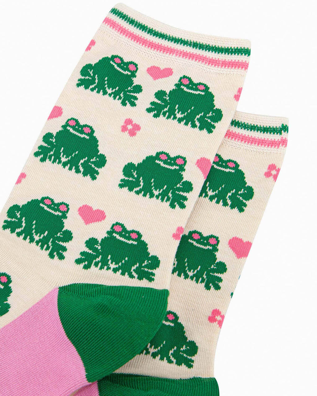 A pair of cream-coloured bamboo socks featuring a fun green frog pattern with pink love hearts and flowers. The socks have a striped green and pink cuff, green heels, and pink soles with ‘Sock Talk’ branding