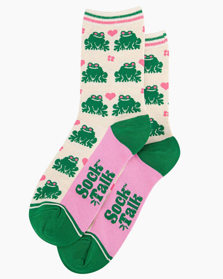 A pair of cream-coloured bamboo socks featuring a fun green frog pattern with pink love hearts and flowers. The socks have a striped green and pink cuff, green heels, and pink soles with ‘Sock Talk’ branding