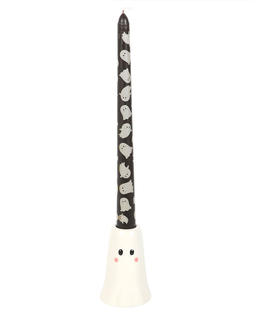 Full view of the Rebel Romance ghost candle and holder set, with the taper candle standing upright in the cute ghost-shaped ceramic holder. The white ceramic contrasts against the black candle and its ghost print.