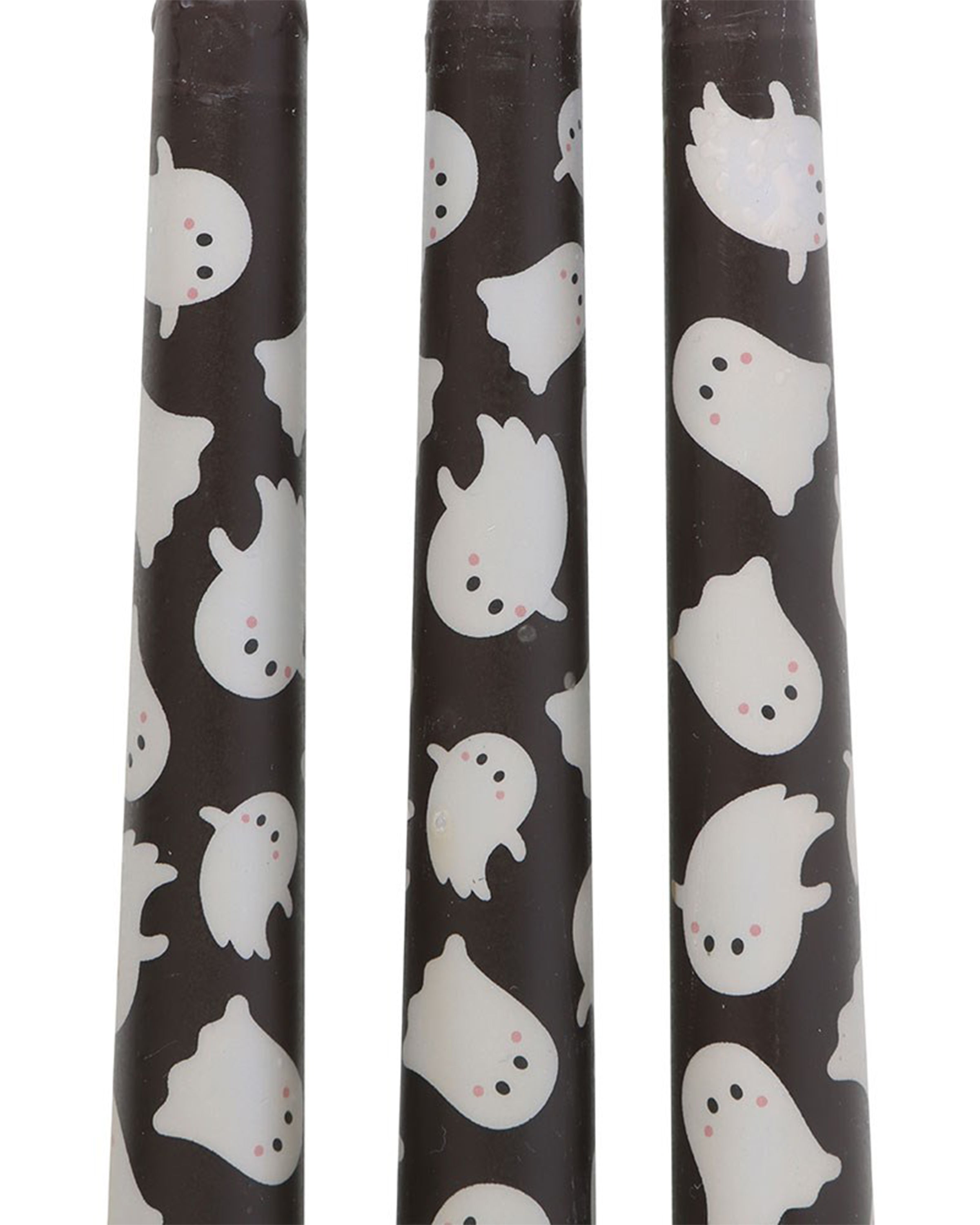 Close-up of three black taper candles with a playful white ghost pattern, designed by Rebel Romance. Each ghost has a cute expression and rosy cheeks, making these candles perfect for spooky Halloween décor or alternative gothic aesthetics. Great for themed tablescapes or gifting.