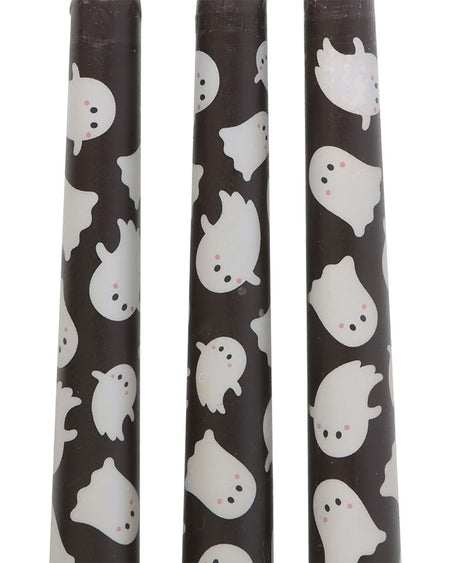 Close-up of three black taper candles with a playful white ghost pattern, designed by Rebel Romance. Each ghost has a cute expression and rosy cheeks, making these candles perfect for spooky Halloween décor or alternative gothic aesthetics. Great for themed tablescapes or gifting.