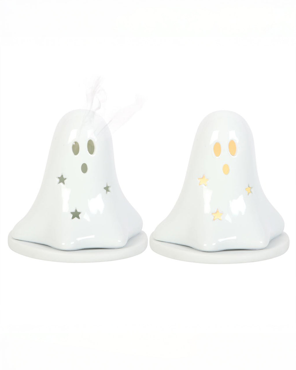 Two white ceramic ghost-shaped holders from Rebel Romance UK – one lit with a tealight glowing through star cut-outs, and one with incense smoke curling from the eyes. A spooky and cute addition to any alternative Halloween home display.