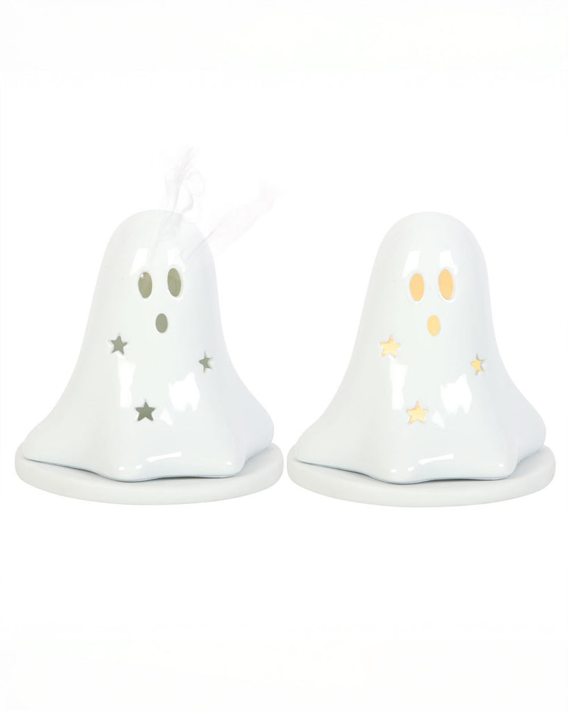 Two white ceramic ghost-shaped holders from Rebel Romance UK – one lit with a tealight glowing through star cut-outs, and one with incense smoke curling from the eyes. A spooky and cute addition to any alternative Halloween home display.