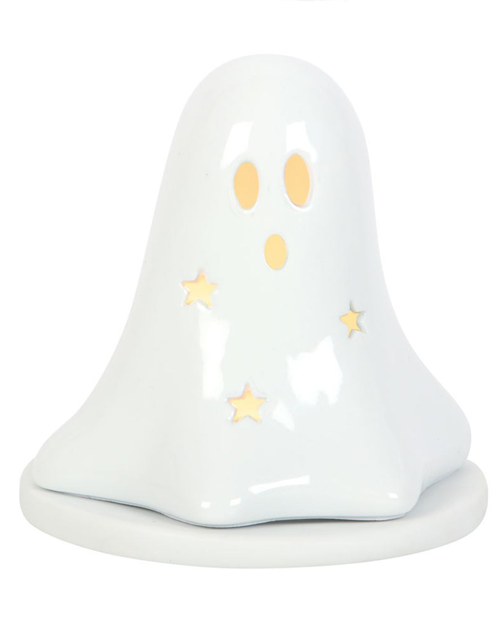 The ceramic ghost tealight holder glowing warmly from within, with light beaming through star and face cut-outs. A whimsical Halloween-themed ornament from Rebel Romance UK, ideal for cosy nights or witchy home décor enthusiasts.