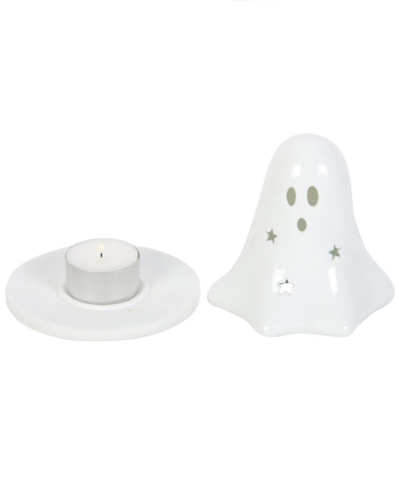 The ceramic ghost-shaped tealight and incense holder from Rebel Romance UK shown in two parts – the white ghost cover with face and star cut-outs, and the matching dish with a tealight inside. A versatile Halloween home accessory for alternative interiors.