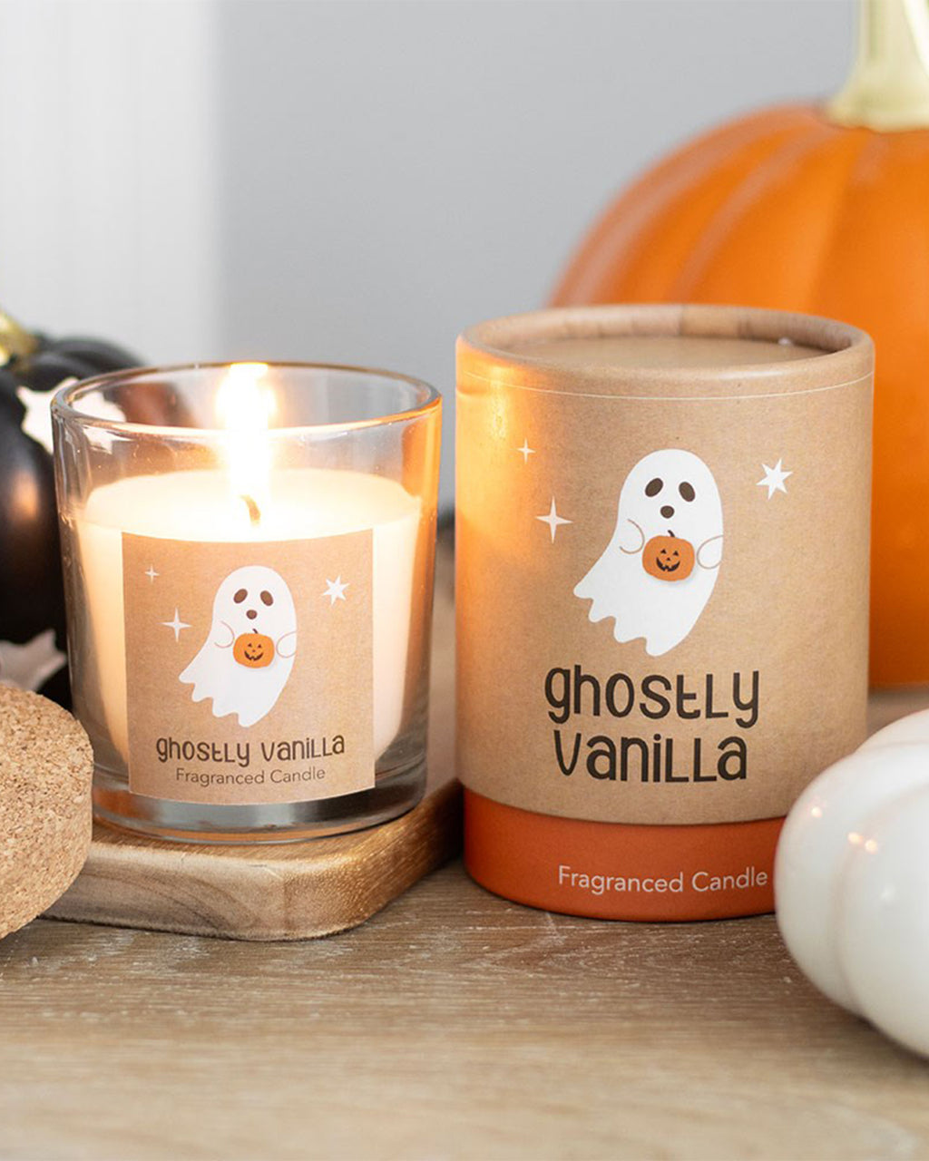 Close-up of the Ghostly Vanilla Candle and its packaging. The kraft paper label features a cute ghost holding a pumpkin, perfect for Halloween gifting.