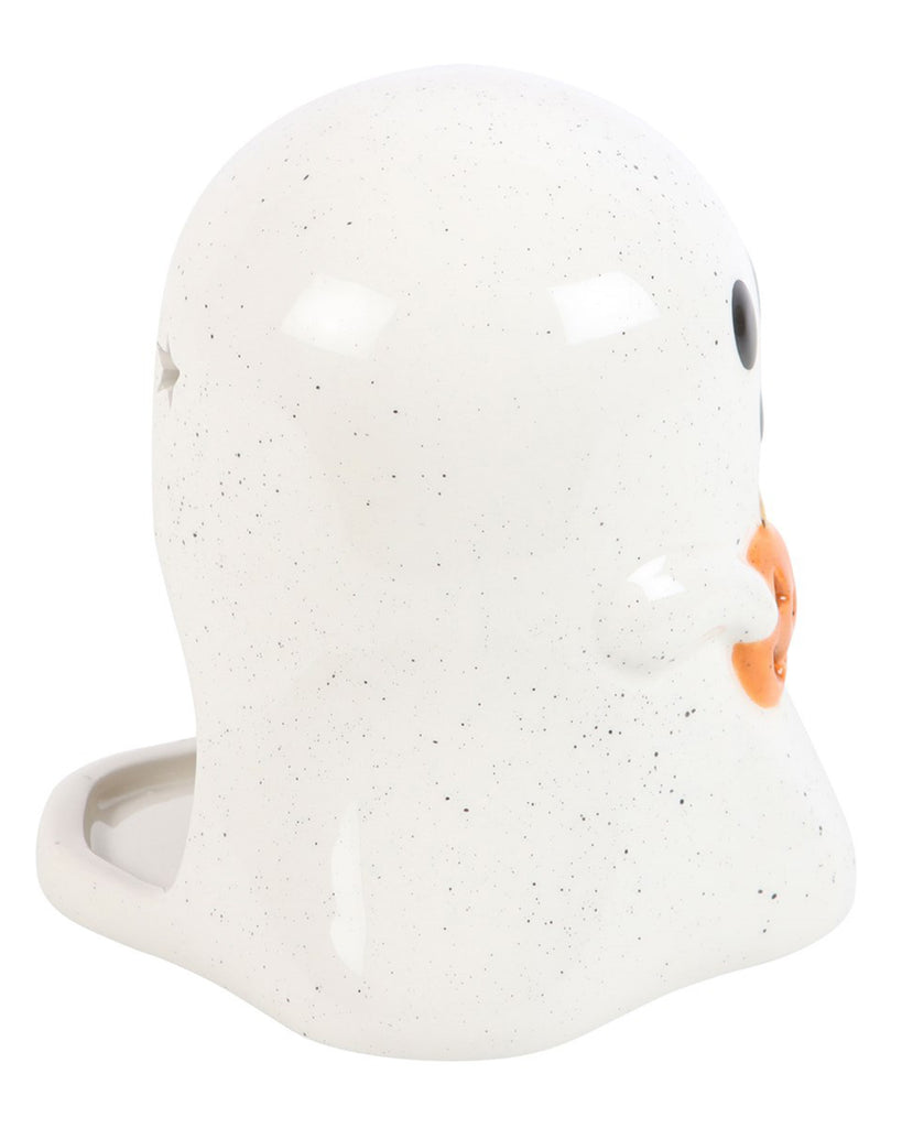 Side angle of Rebel Romance ghost tealight holder showing its speckled white ceramic finish and mini jack-o’-lantern pumpkin detail. A quirky Halloween decoration for cosy gothic vibes.