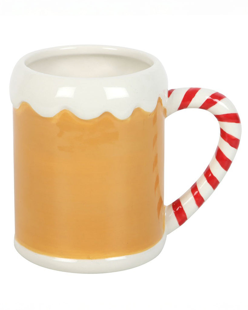 A festive ceramic mug from Rebel Romance shaped like a gingerbread house with a glossy caramel brown body, white icing detail around the rim and a candy cane striped handle. Perfect for alternative homeware lovers and cosy winter drinks.