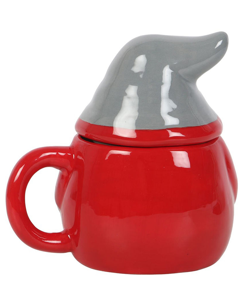 Side view of the Christmas gnome mug with curved red handle and ceramic grey hat-shaped lid.