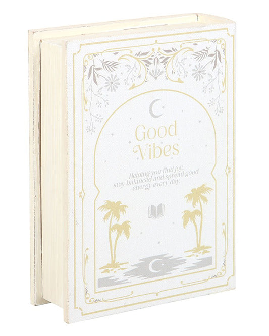 Front view of Good Vibes book-shaped storage box by Rebel Romance. Features a cream and gold celestial and botanical design with the words “Good Vibes,” making it a chic home accessory that doubles as hidden storage.