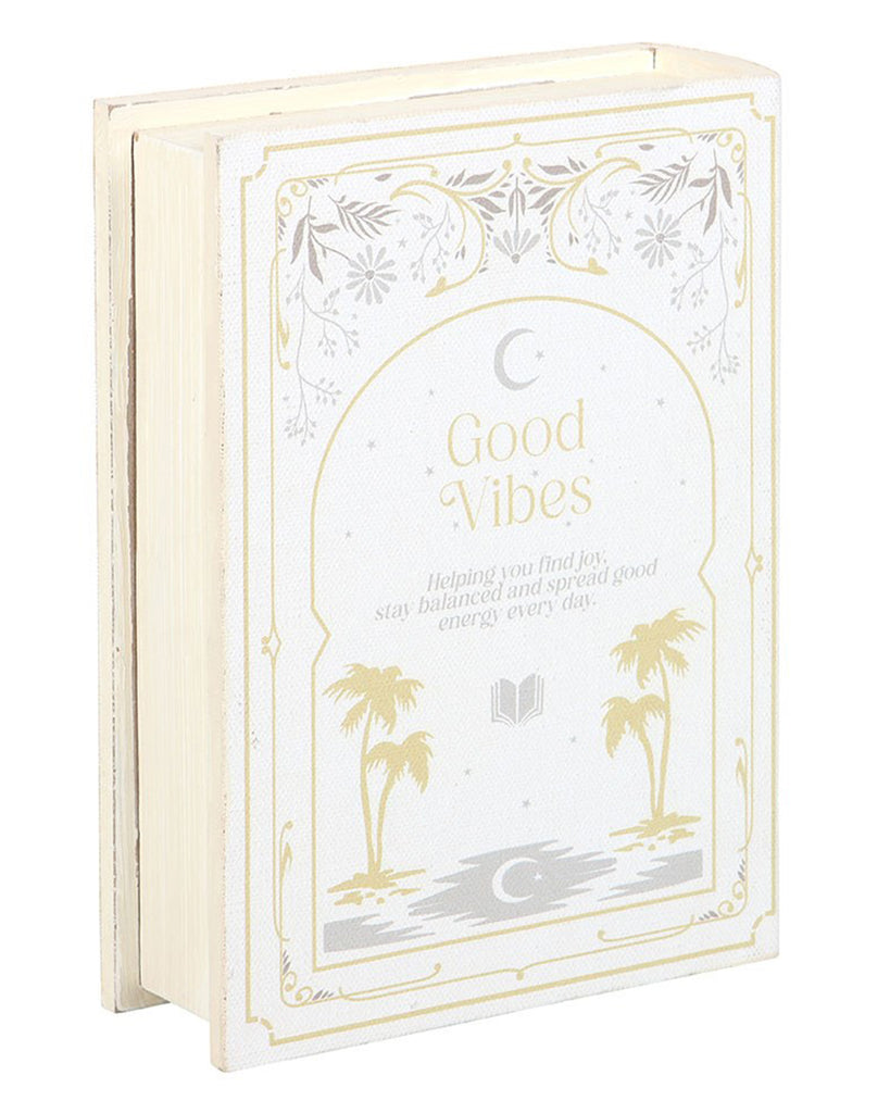 Front view of Good Vibes book-shaped storage box by Rebel Romance. Features a cream and gold celestial and botanical design with the words “Good Vibes,” making it a chic home accessory that doubles as hidden storage.