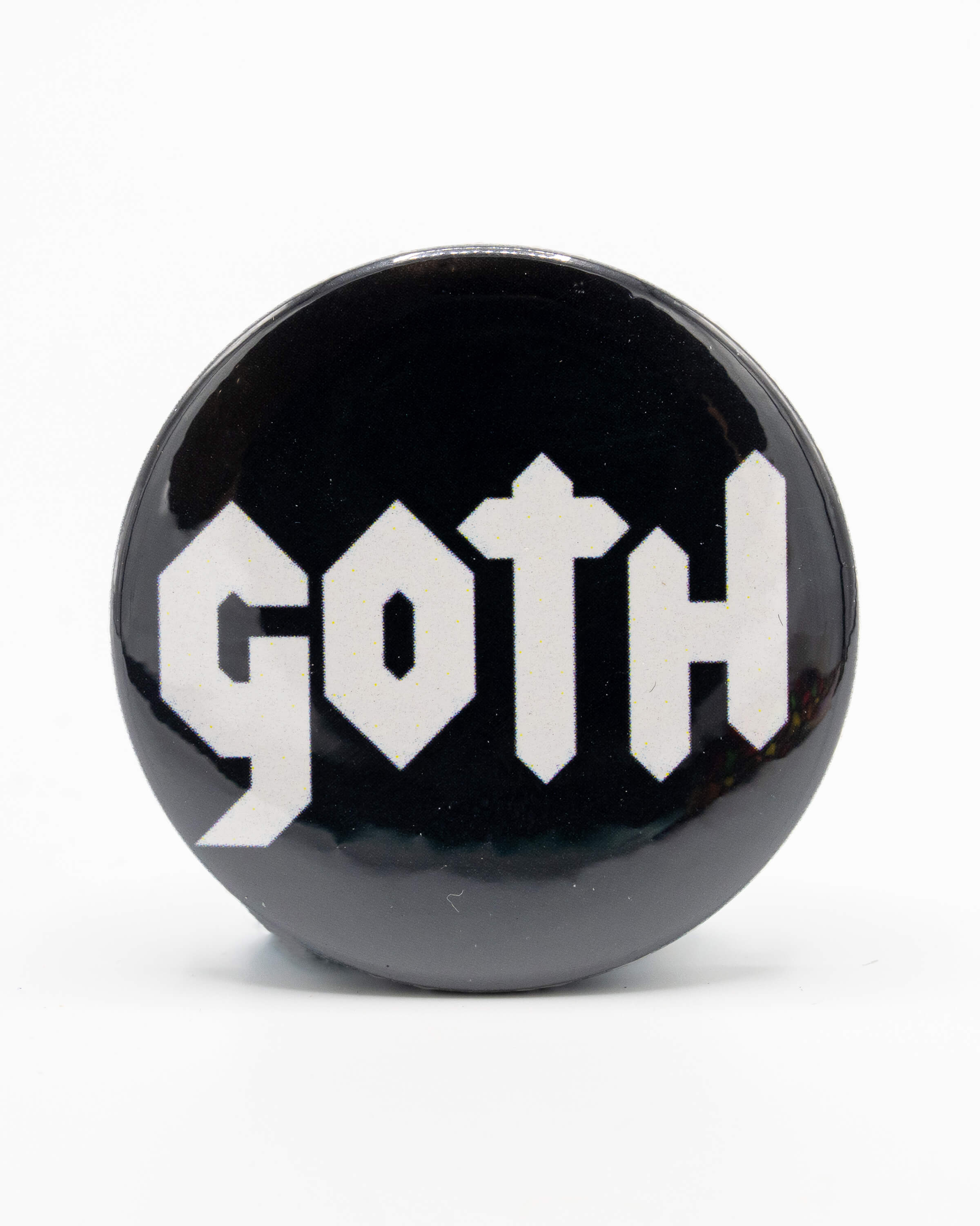 Black button badge with 'Goth' written in the centre in a white gothic style font. A retro inspired design by Bite Your Granny.