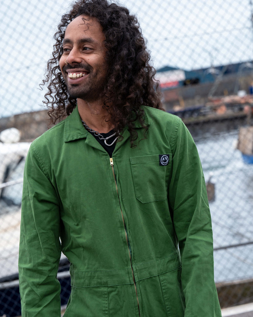 Richard smiling in the Rebel Romance Forest Green Boiler Suit, showing the chest pocket and front zip detail.