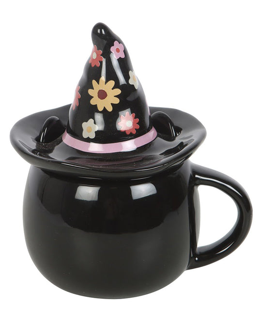 Back view of the Groovy Witch Cat Mug by Rebel Romance. The glossy black ceramic mug features a floral witch hat lid with pink, red, and yellow daisy-like flowers. A cute Halloween-themed gift and alternative kitchenware item.