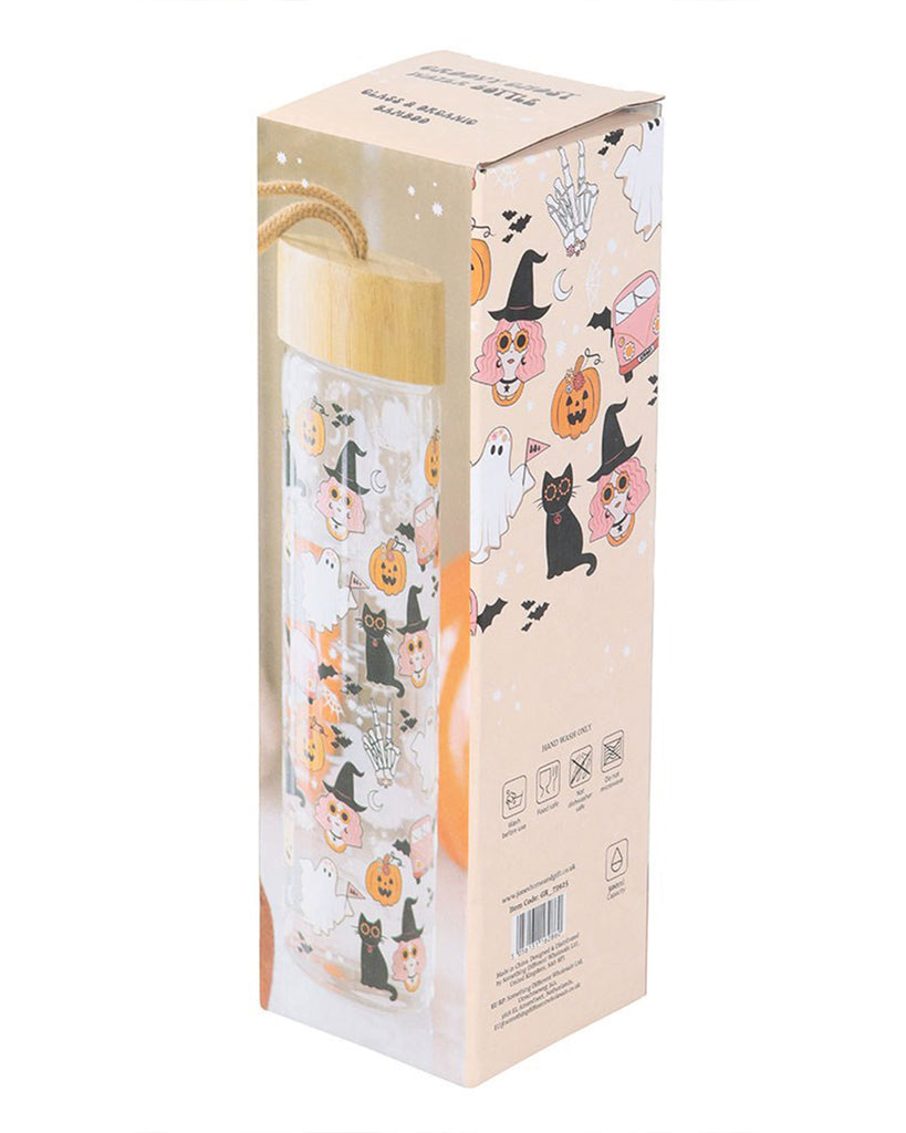 Groovy Ghost Print Glass Water Bottle by Rebel Romance, shown in its pastel Halloween-themed packaging. The design features pumpkins, witches, black cats, skeleton hands, ghosts, and retro vans in orange, pink and black tones, with a bamboo lid and carry loop. A quirky and spooky hydration essential.