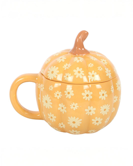 Side angle of the Groovy Floral Pumpkin Lidded Mug from Rebel Romance. Its curved pumpkin stem lid, bold daisy pattern, and rounded shape make it a whimsical addition to any autumn or Halloween homeware setup.