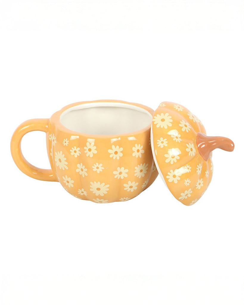 Side view of the Rebel Romance Groovy Floral Pumpkin Mug with the lid removed, showing the roomy interior. Designed for cosy autumn drinks, it features an all-over daisy print on orange ceramic with a pumpkin shape and quirky charm.