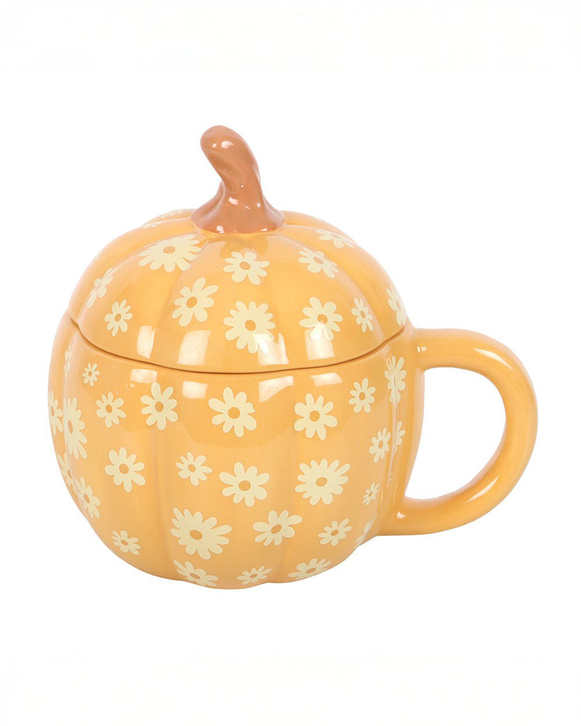 Front-facing view of the Rebel Romance Groovy Floral Pumpkin Lidded Mug. Shaped like a pumpkin with a curved stem lid, this orange ceramic mug features a daisy print pattern in a retro floral style. Quirky and ideal for cosy autumn drinks.