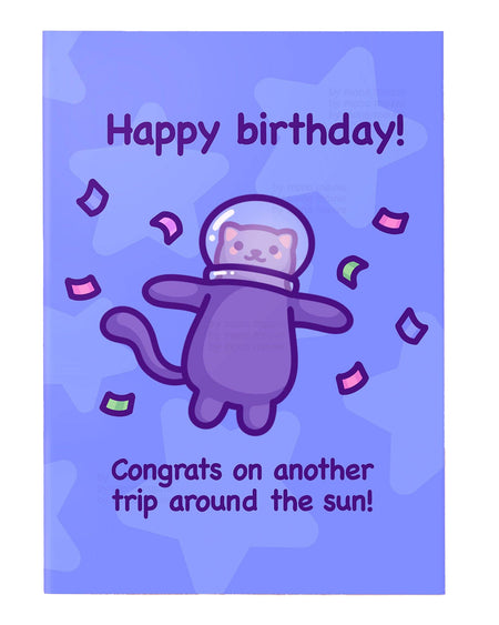 Purple birthday greeting card designed by Mona Mauve for Rebel Romance, featuring a cute cartoon cat in a space helmet floating with confetti on a starry lavender background. The card says “Happy birthday! Congrats on another trip around the sun!” A fun, space-themed birthday card ideal for cat lovers and fans of quirky illustrations.