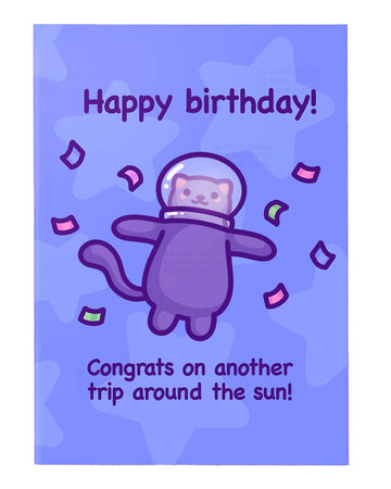 Purple birthday greeting card designed by Mona Mauve for Rebel Romance, featuring a cute cartoon cat in a space helmet floating with confetti on a starry lavender background. The card says “Happy birthday! Congrats on another trip around the sun!” A fun, space-themed birthday card ideal for cat lovers and fans of quirky illustrations.