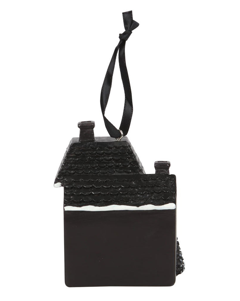 Back view of the Haunted Holiday House resin ornament from Rebel Romance, showing the snow-dusted roof and gothic black finish, a plain black back of the house with a black ribbon for hanging.