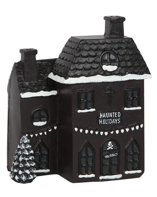 Side view of the Haunted Holiday House Incense Burner with hand-painted snow, skull detail on the front door, and “Haunted Holidays” text on the building.