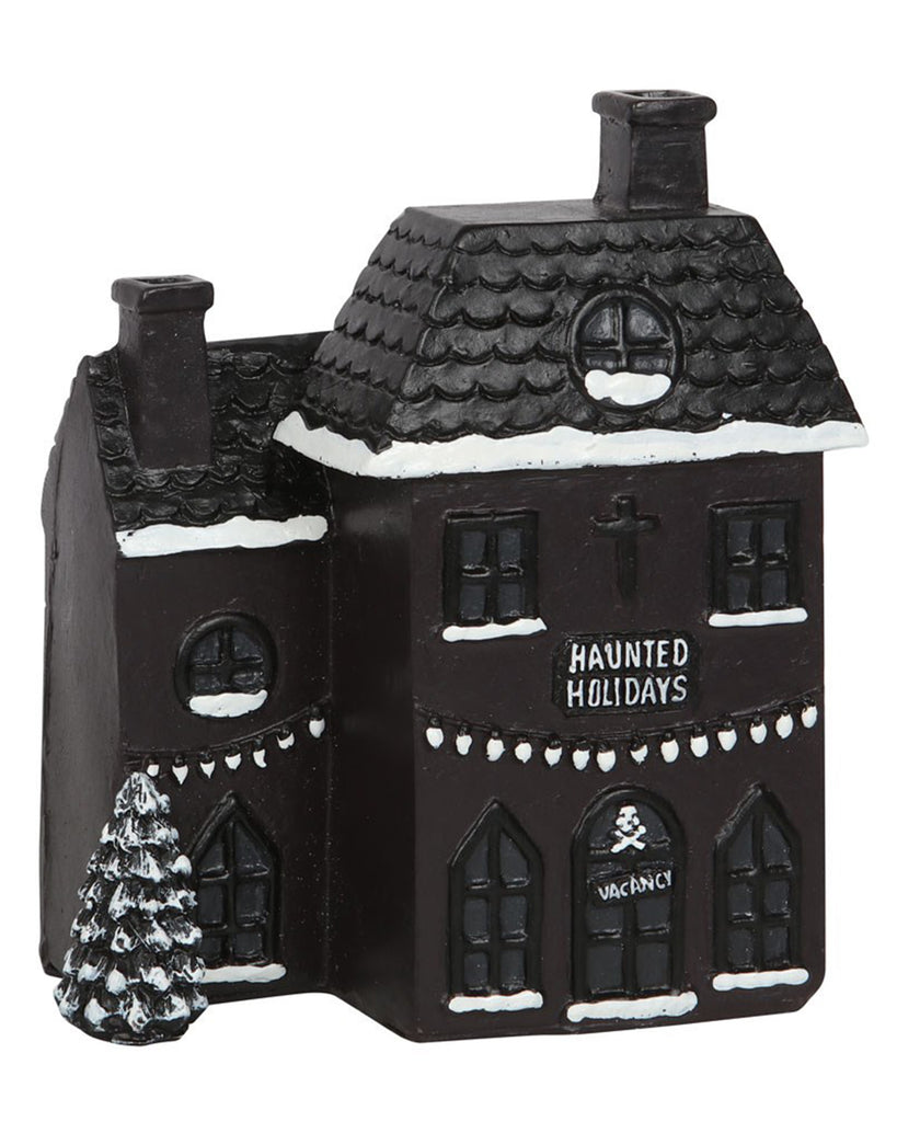 Side view of the Haunted Holiday House Incense Burner with hand-painted snow, skull detail on the front door, and “Haunted Holidays” text on the building.
