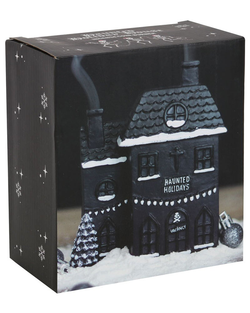 Packaging for the Haunted Holiday House Incense Burner by Rebel Romance, showing the gothic ceramic house in snow with festive horror detailing.