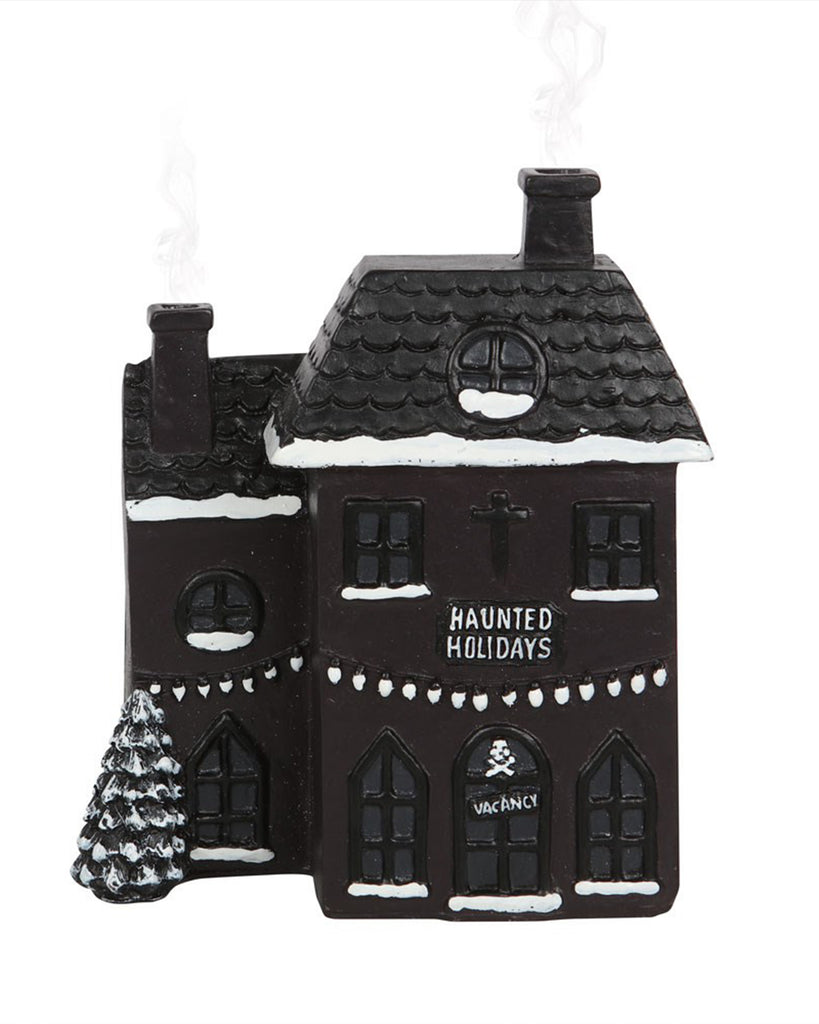 Front-facing view of Rebel Romance's Haunted Holiday House Incense Burner, with smoke gently wafting from the chimneys for a spooky Christmas touch.