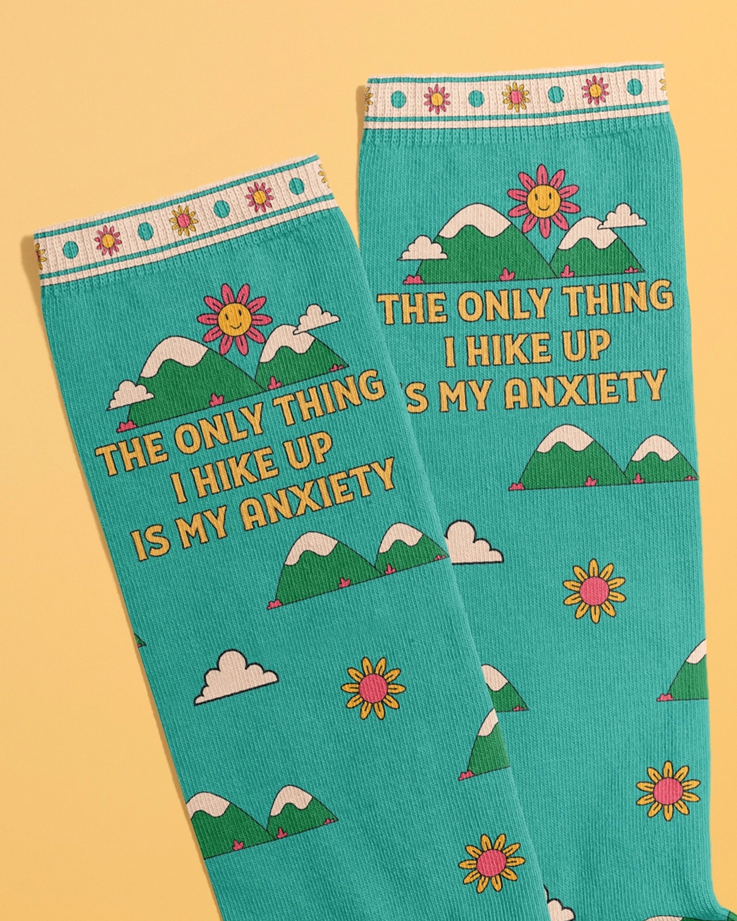 Close-up of teal crew socks by Rebel Romance featuring the phrase 