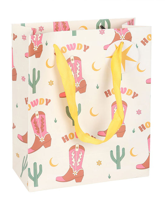 Rebel Romance medium gift bag featuring pink Western boots, cacti and moons, with bright yellow ribbon handles and a matching star gift tag for celebrations.