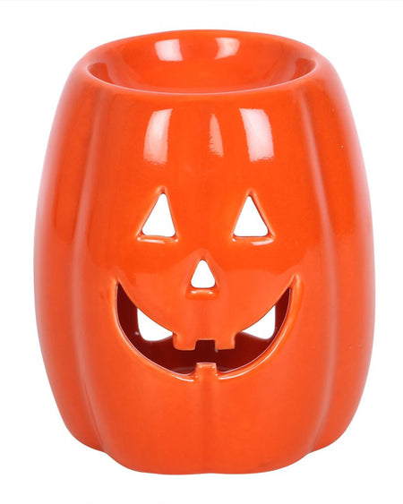 Front view of Rebel Romance’s Jack-o’-Lantern oil burner, featuring star-shaped cut-out eyes and a lit tealight inside. Perfect for melting wax and adding cosy Halloween charm to your décor.