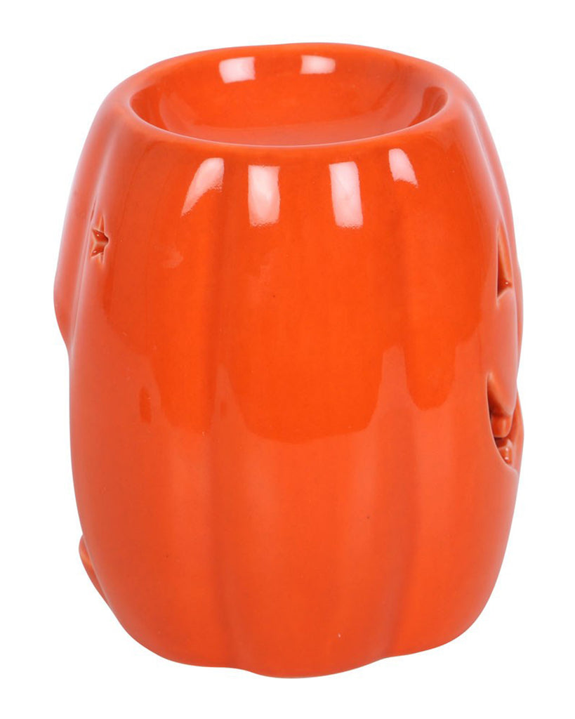 Angled side view of the Rebel Romance pumpkin wax warmer showing its star-shaped eye cut-outs and curved design. Adds a fun gothic touch to any spooky space.