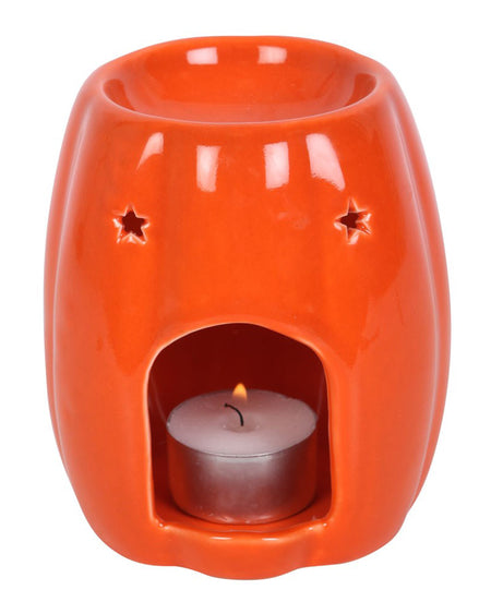 Bright orange ceramic oil burner by Rebel Romance shaped like a pumpkin, with a smooth, glossy finish. A bold Halloween home accessory ideal for wax melts or essential oils.